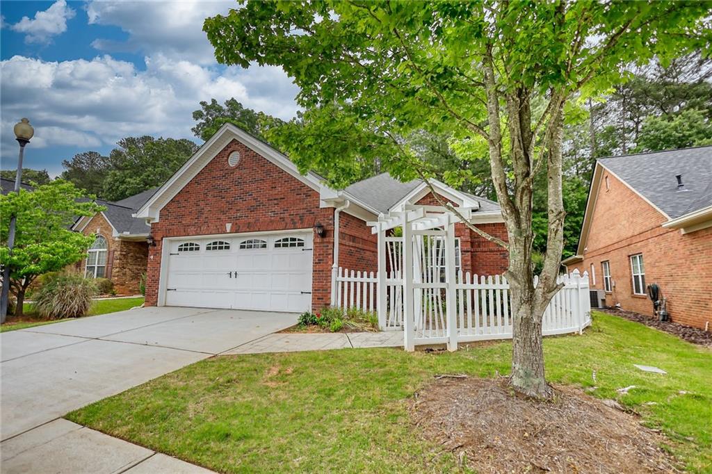 10169 Malcolm Drive Covington, GA 30014 - Photo 1 of 1 a front view of a house with a garden
