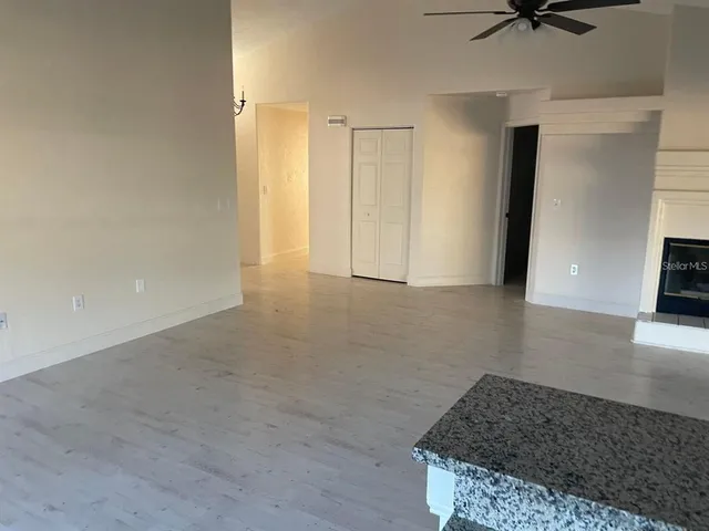 a kitchen with granite countertop a sink a stove and a granite counter top
