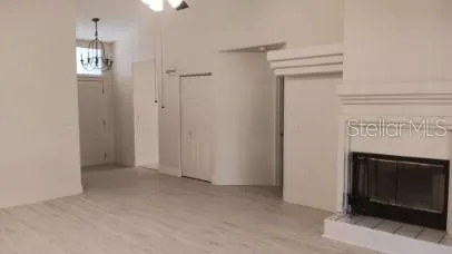 a view of empty room with window and fireplace