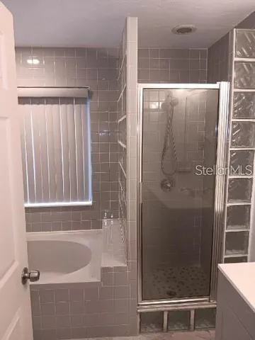 a bathroom with a bathtub and shower