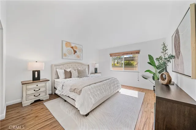 a living room with a bed furniture and a potted plant
