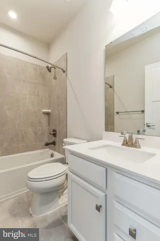 a bathroom with a sink toilet vanity and shower