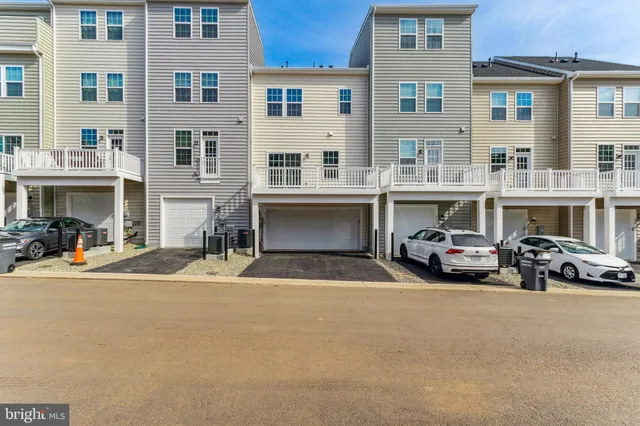 a view of building with cars parked in front of it