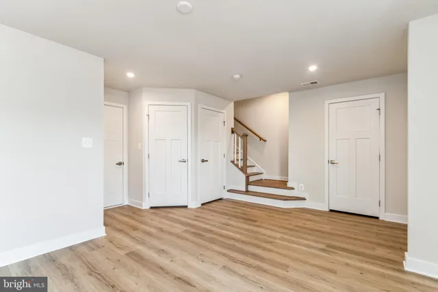 a view of a room with wooden floor