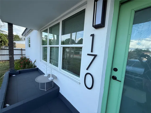 a view of backyard with a plants and trees