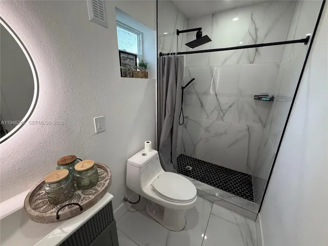 a kitchen that has a refrigerator a sink and a stove