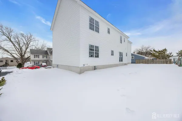a view of the house with a snow in the yard