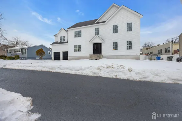 a view of white house with a road