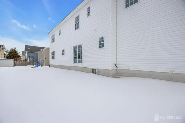 a view of a building with snow on the road