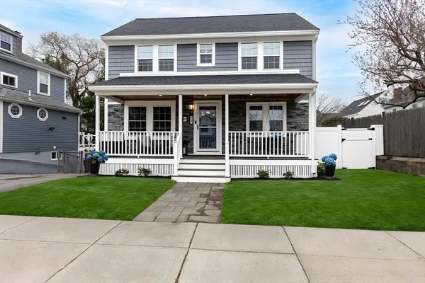 a front view of a house with a garden