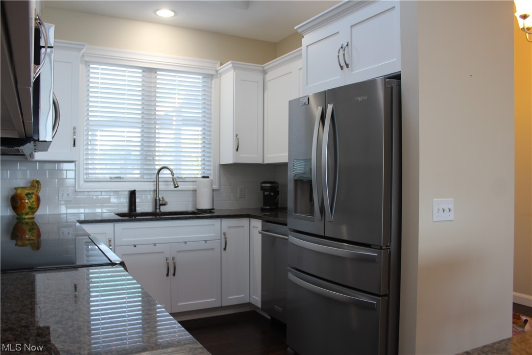 122 Turtle Bay Huron, OH 44839 - Photo 5 of 31 Kitchen featuring tasteful backsplash, white cabinetry, and appliances with stainless steel finishes