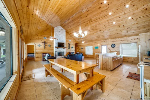 a living room with fireplace furniture and a large window