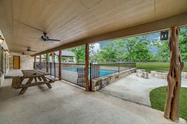 a view of a patio with table and chairs next to a yard