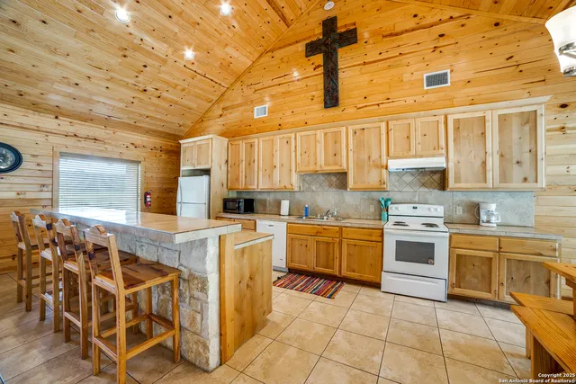 a kitchen with stainless steel appliances granite countertop a stove and cabinets