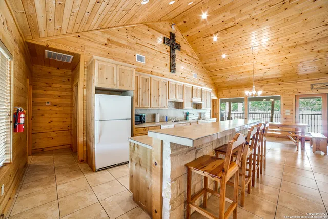 a view of a patio with dining table and chairs