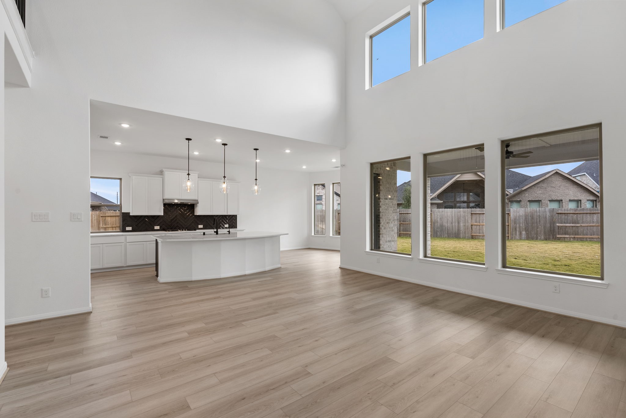 18810 Forested Street Manvel, TX 77578 - Photo 13 of 35 a living room with stainless steel appliances kitchen island hardwood floor and a large window