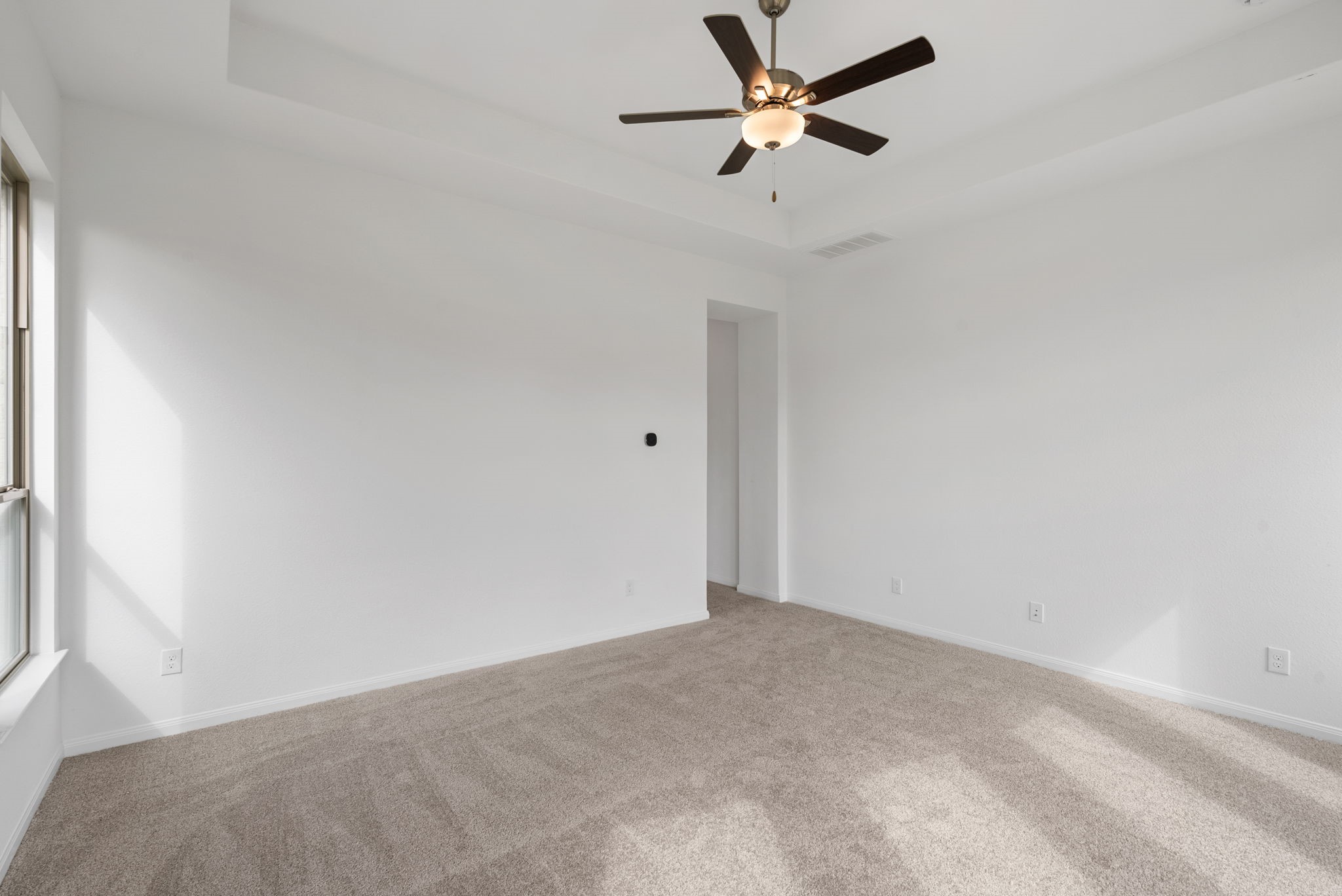 18810 Forested Street Manvel, TX 77578 - Photo 26 of 35 an empty room with a window and a fan