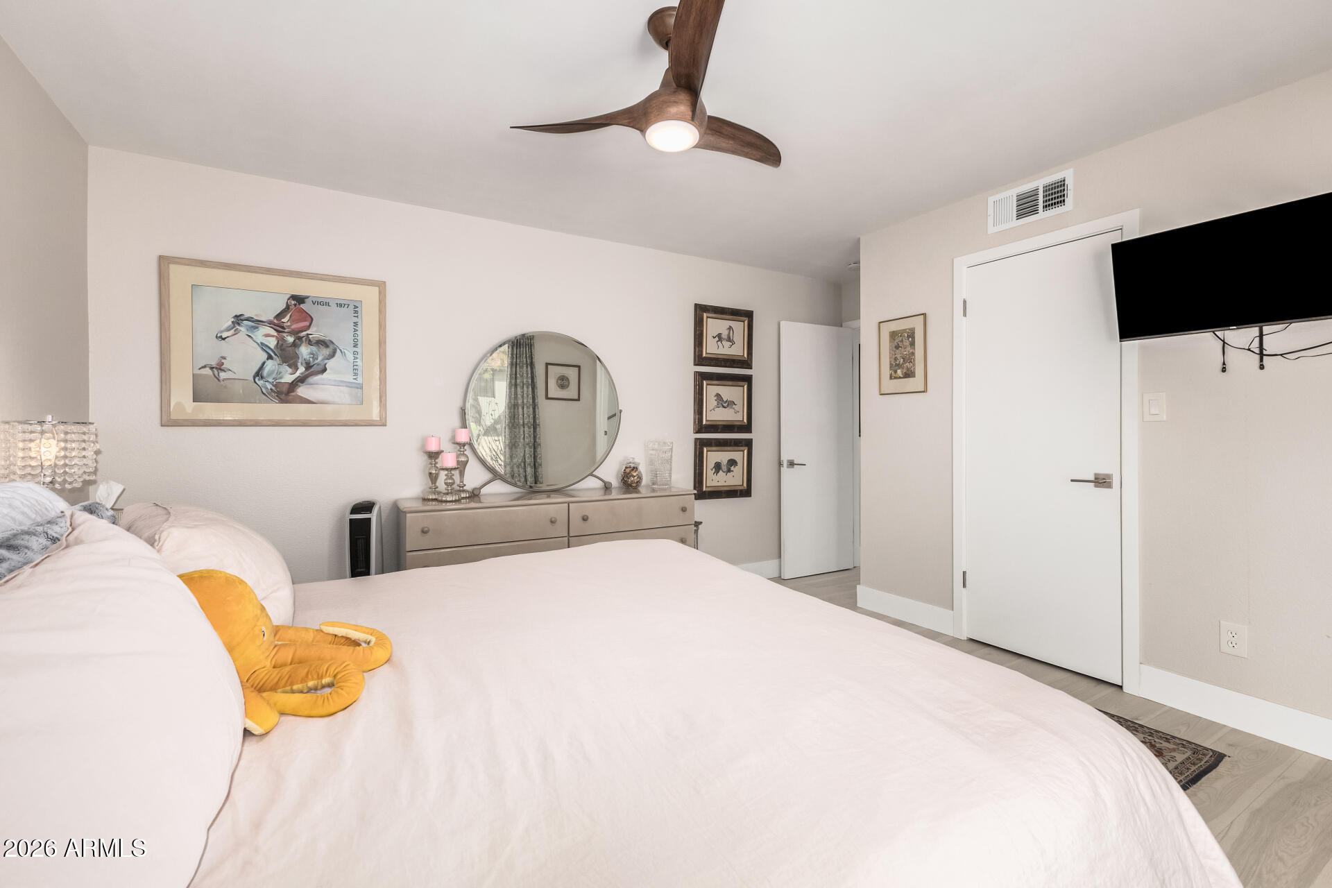 26055 North Bravo Lane Rio Verde, AZ 85263 - Photo 12 of 26 a bedroom with a bed and a chandelier