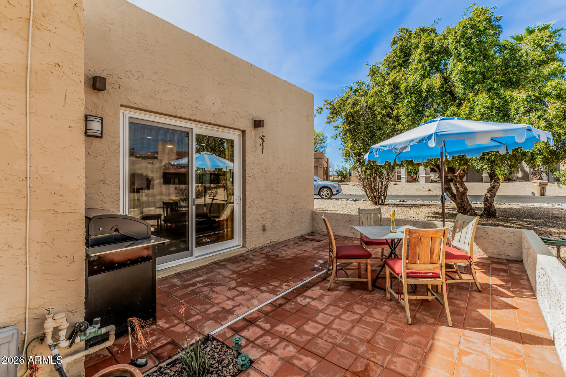 26055 North Bravo Lane Rio Verde, AZ 85263 - Photo 17 of 26 a patio with a table and chairs under an umbrella