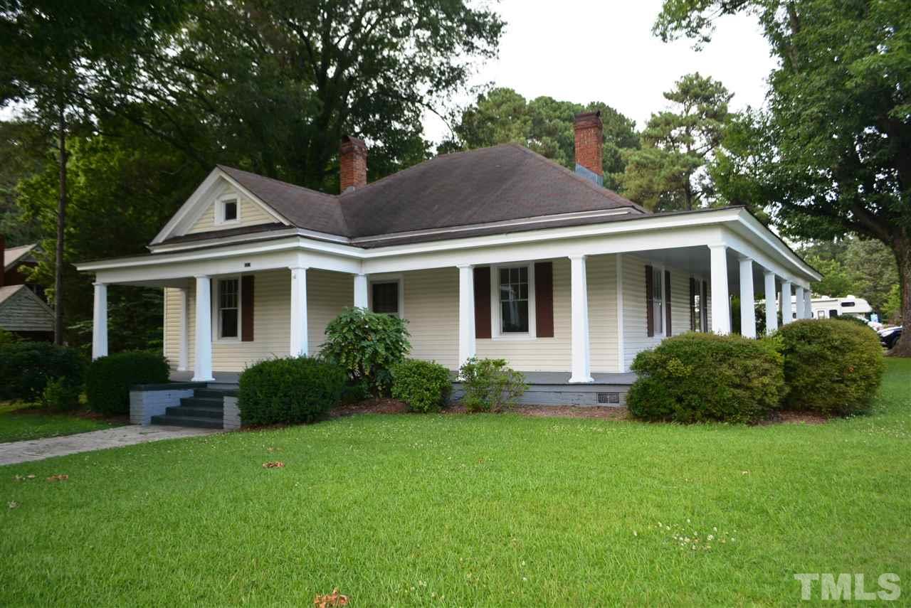 317 South Walnut Street Spring Hope, NC 27882 - Photo 2 of 14 a front view of a house with a yard and porch