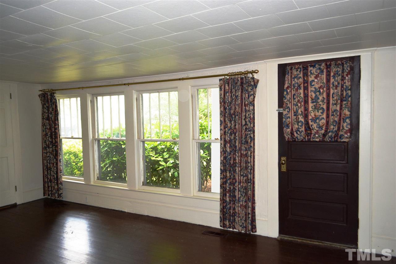 317 South Walnut Street Spring Hope, NC 27882 - Photo 11 of 14 an empty room with wooden floor and windows