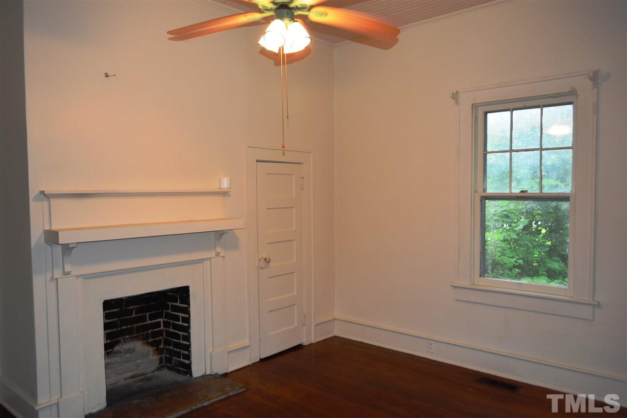 317 South Walnut Street Spring Hope, NC 27882 - Photo 9 of 14 an empty room with wooden floor fan and windows