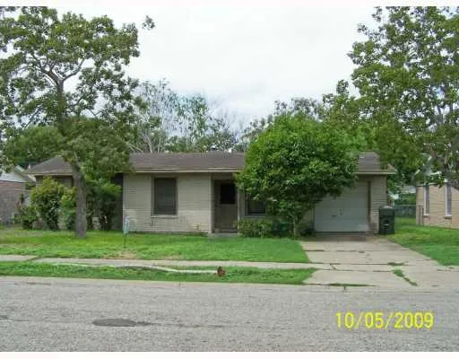 a view of a house with a yard and large tree