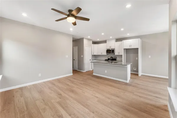 a view of kitchen with refrigerator and microwave