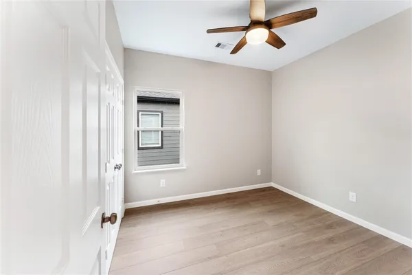wooden floor in an empty room with a window