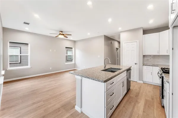 a kitchen with a stove and a sink