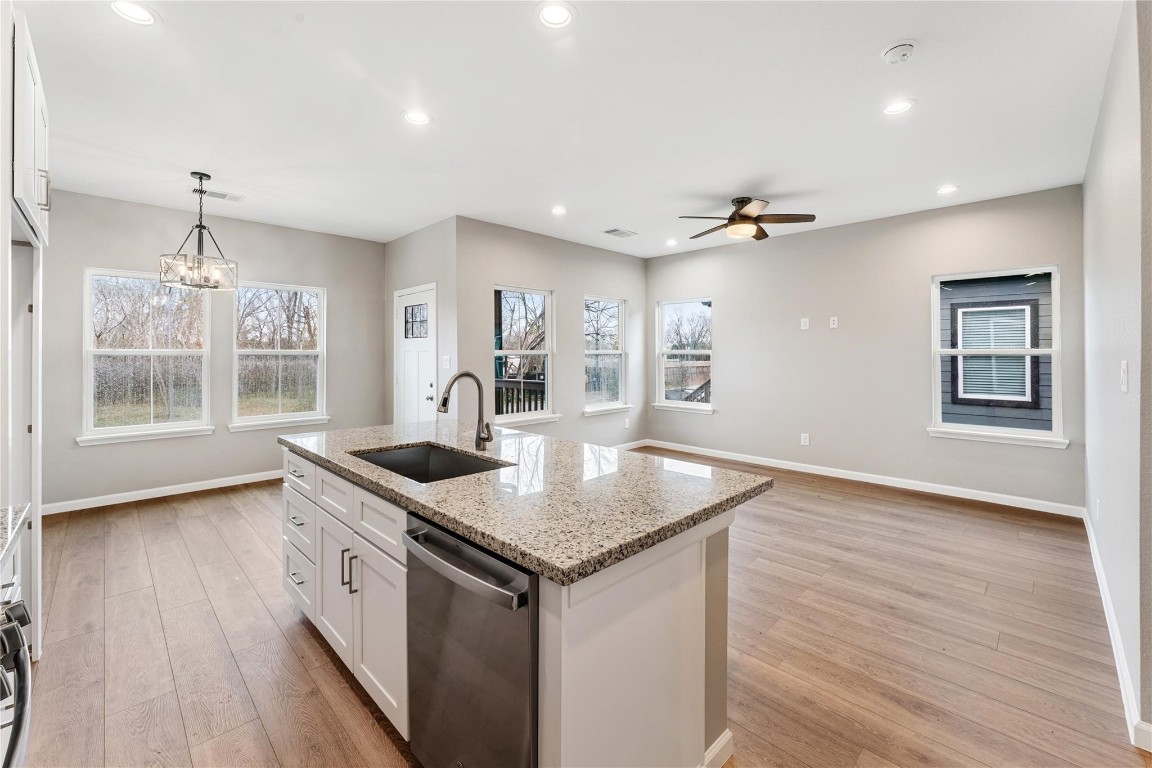 4902 Rue Street, Unit B Houston, TX 77033 - Photo 8 of 24 a kitchen with stainless steel appliances granite countertop a sink stove and wooden floor
