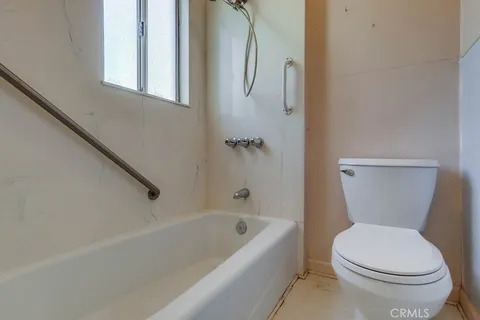 a bathroom with a toilet and a bathtub