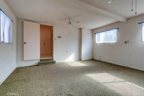 a view of a house with snow on the side of the road
