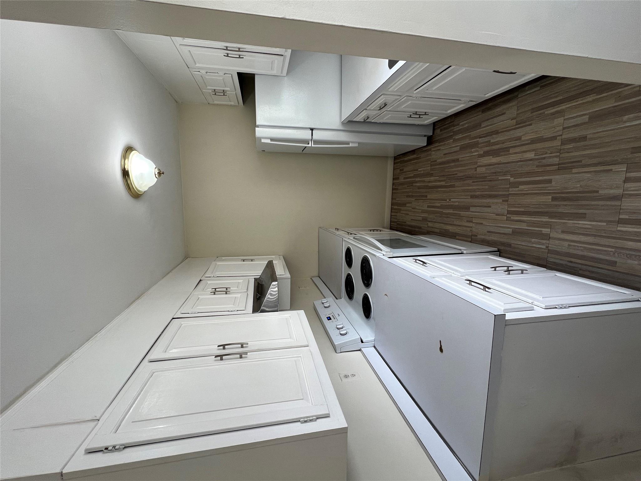 20 Pierces Road, Unit 4 Newburgh, NY 12550 - Photo 1 of 1 Kitchen with white cabinetry, range, fridge, dark hardwood / wood-style flooring, and range hood