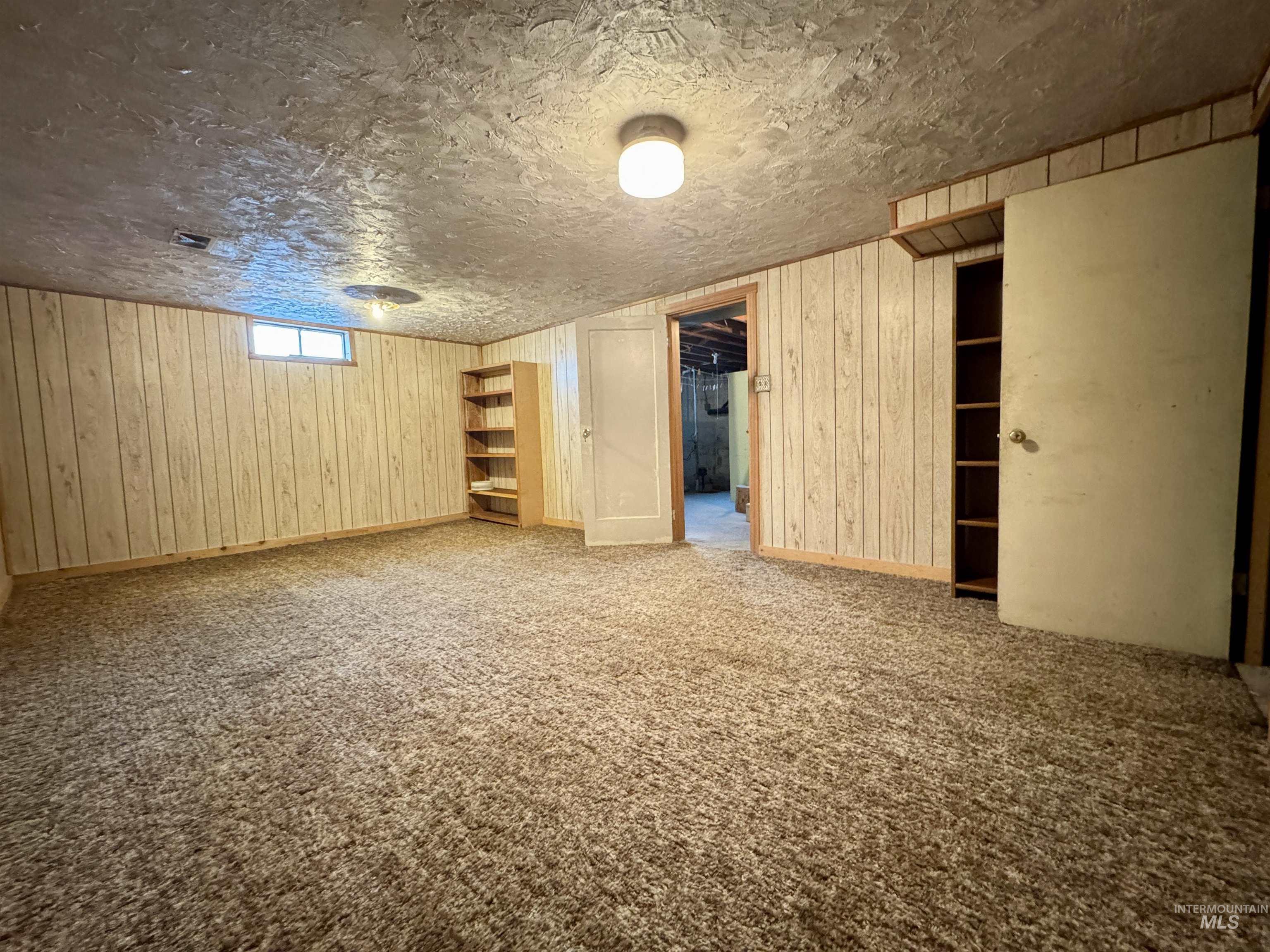3989 North 2250 East Filer, ID 83328 - Photo 18 of 26 Basement with wooden walls and carpet floors