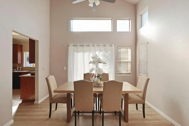 a dining room with furniture and window