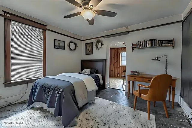 a bedroom with a bed and a chair