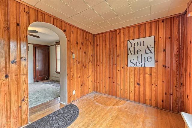 a view of hallway with wooden floor and door