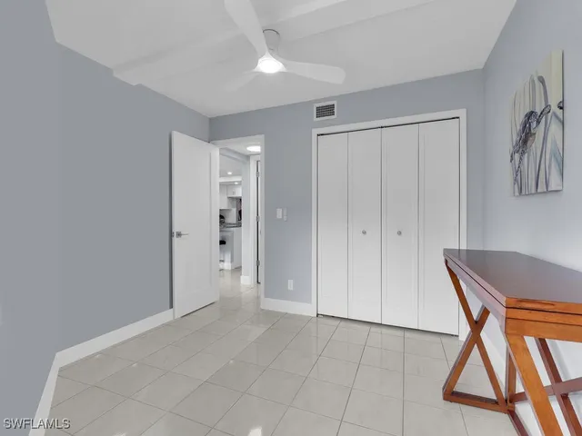 a view of an entryway with a flower pot and a dining table