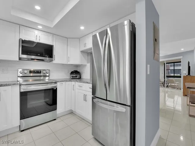 a view of a dining room with furniture and a chandelier