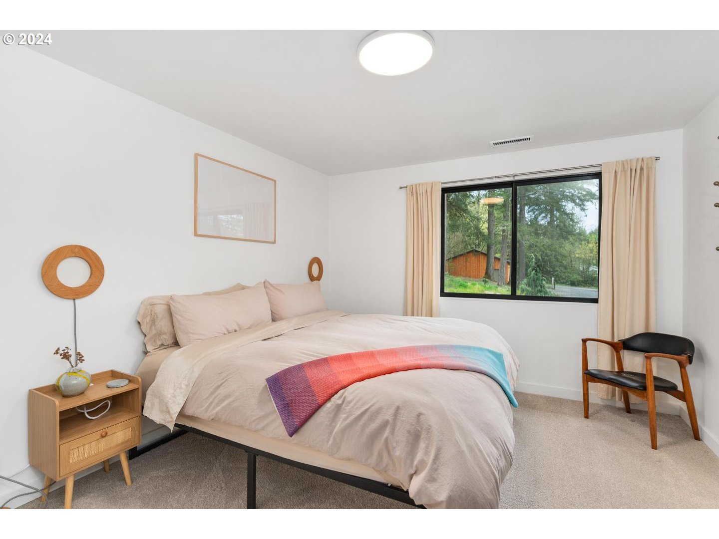 14425 Northwest Cornelius Pass Road Portland, OR 97231 - Photo 19 of 48 a bedroom with a bed and a window