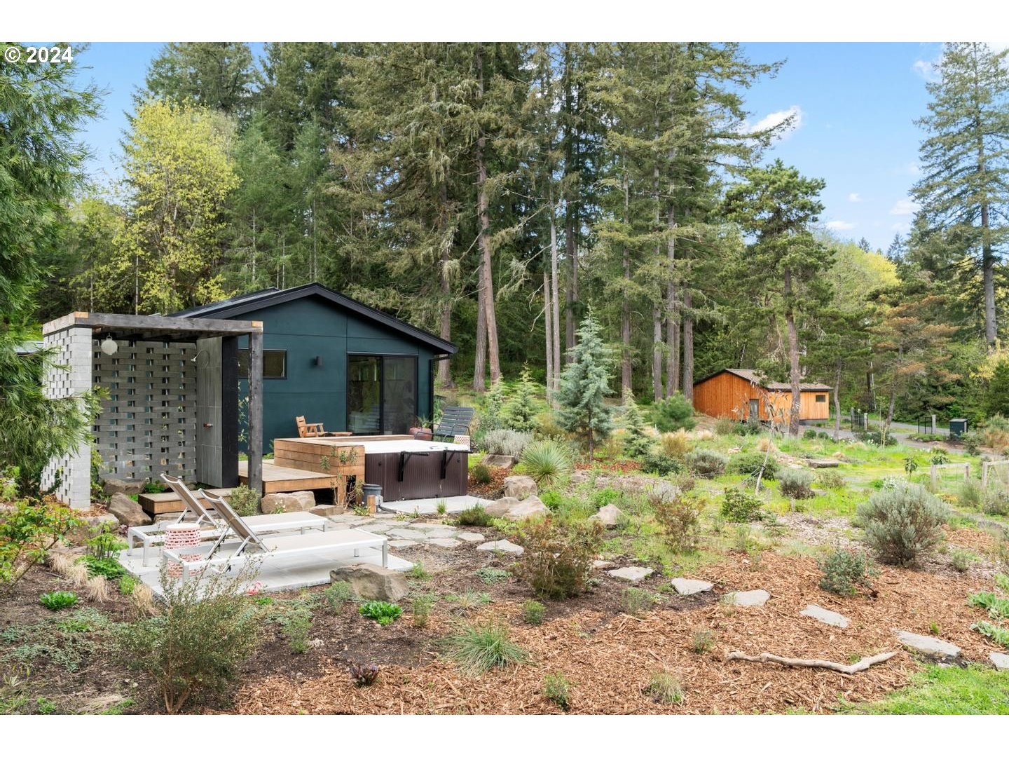 14425 Northwest Cornelius Pass Road Portland, OR 97231 - Photo 4 of 48 a view of a house with a yard and sitting area