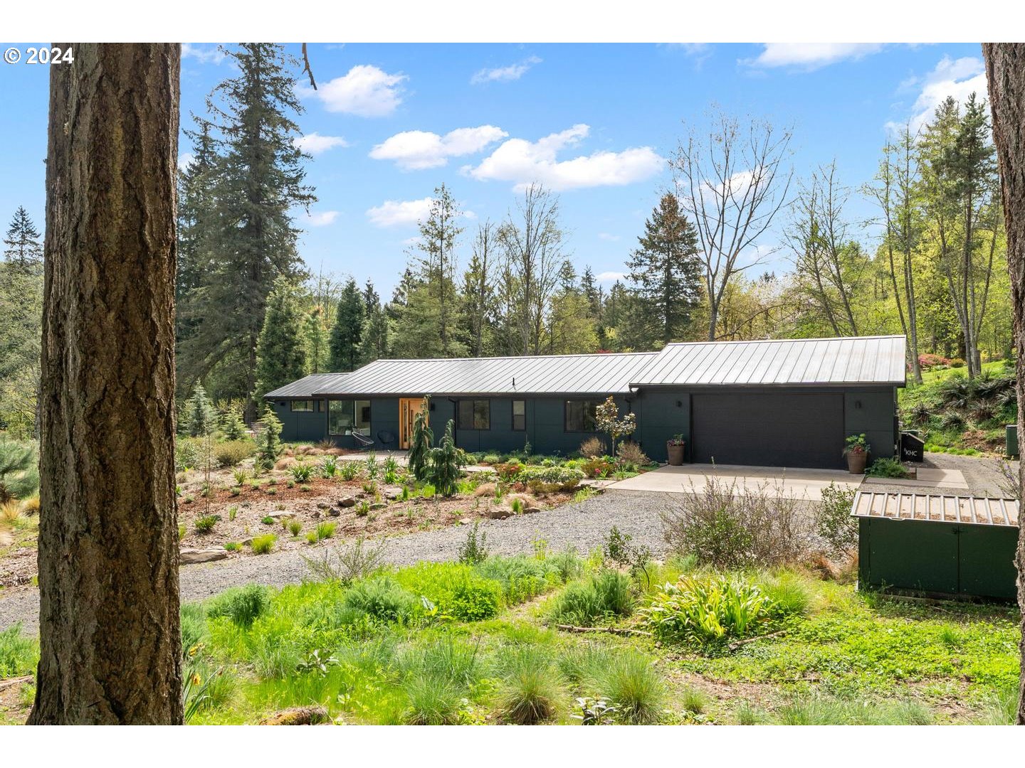 14425 Northwest Cornelius Pass Road Portland, OR 97231 - Photo 46 of 48 a view of a backyard with a garden and trees