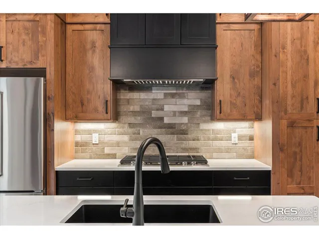 a kitchen with a counter space a sink appliances and cabinets