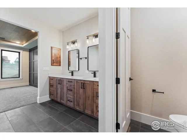 a spacious bathroom with a double vanity sink and a mirror