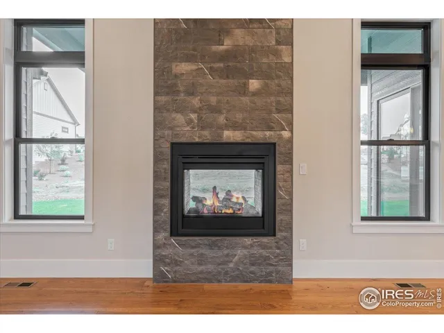 a view of a room with a ceiling fan and wooden floor