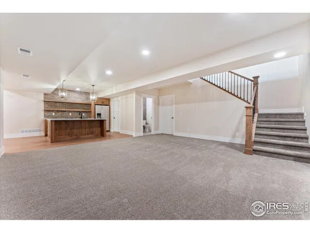 a kitchen with a sink a refrigerator and chandelier