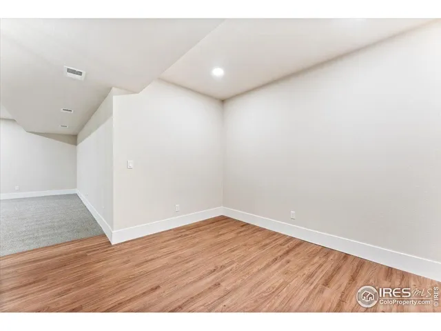 a bathroom with a granite countertop sink vanity mirror and toilet