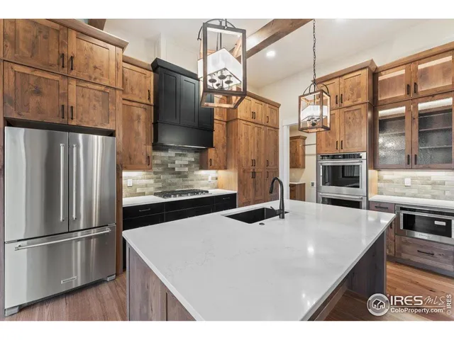 a kitchen with stainless steel appliances a sink stove and cabinets