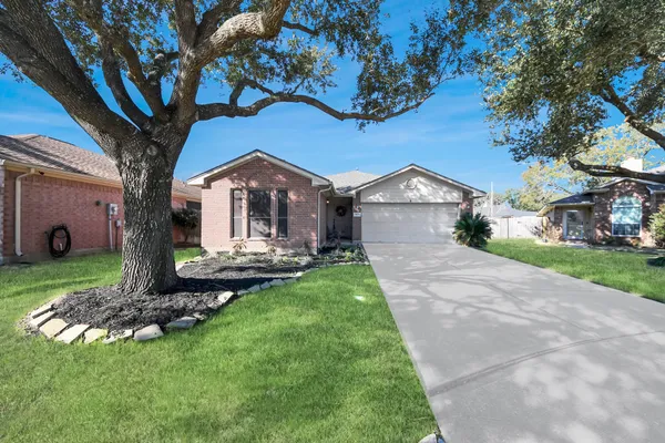 a front view of a house with a garden and yard